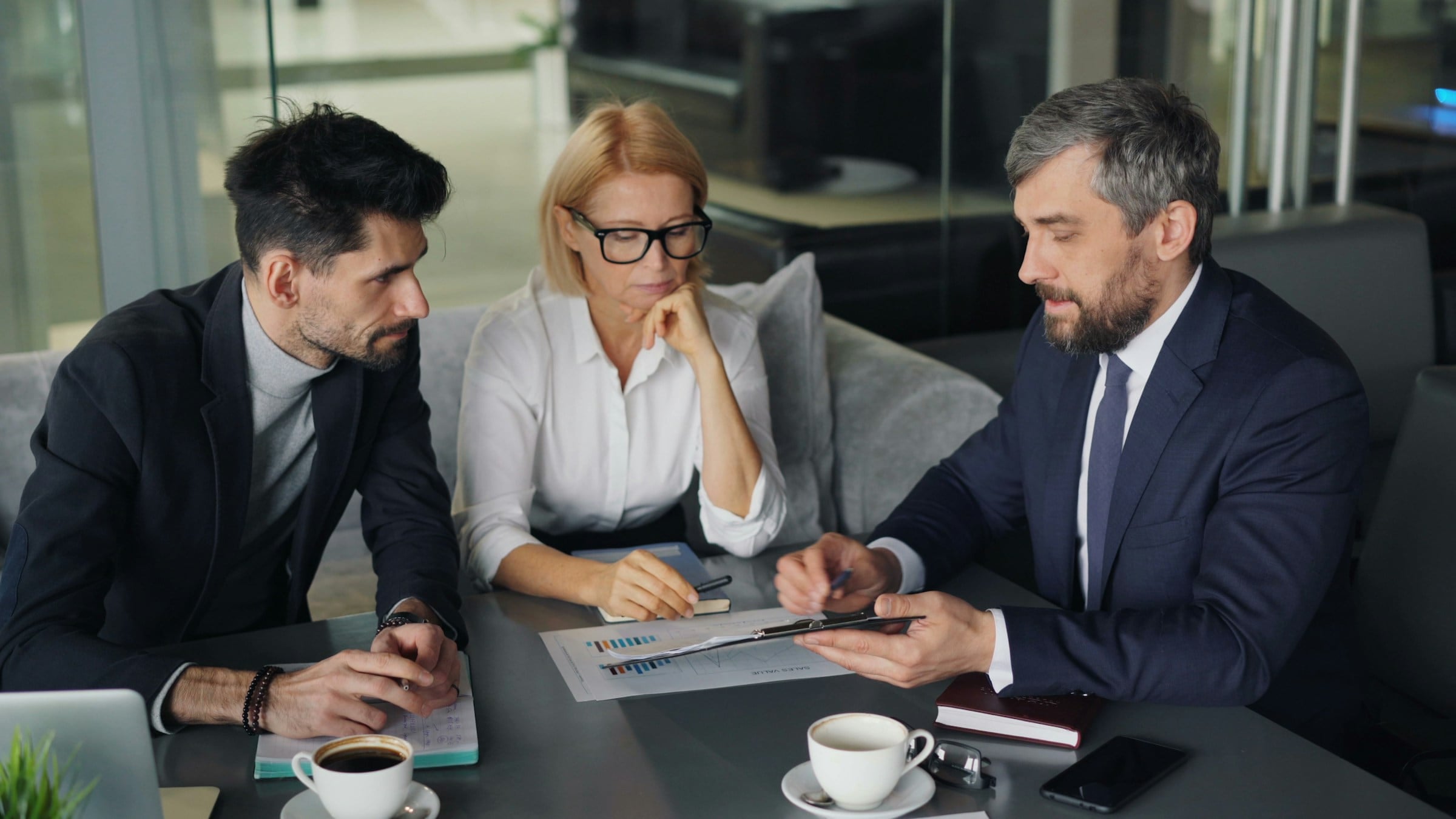 Advisers and a client reviewing plans together