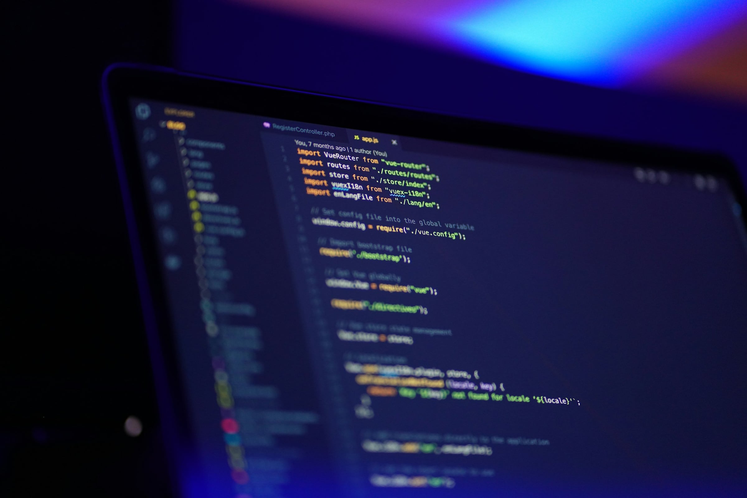 Developer's laptop showing website code on a desk