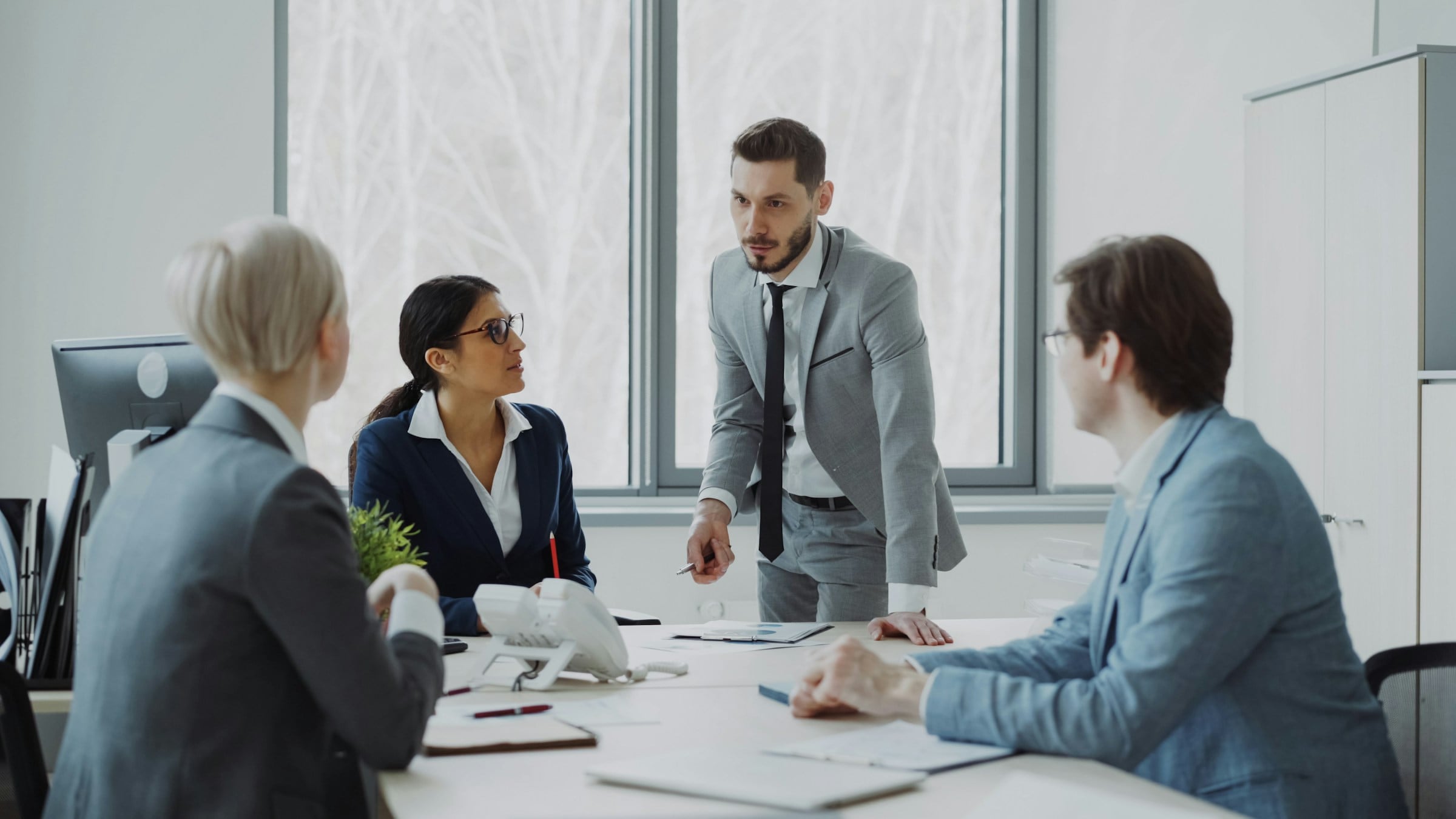 Consultants advising a client across a meeting table