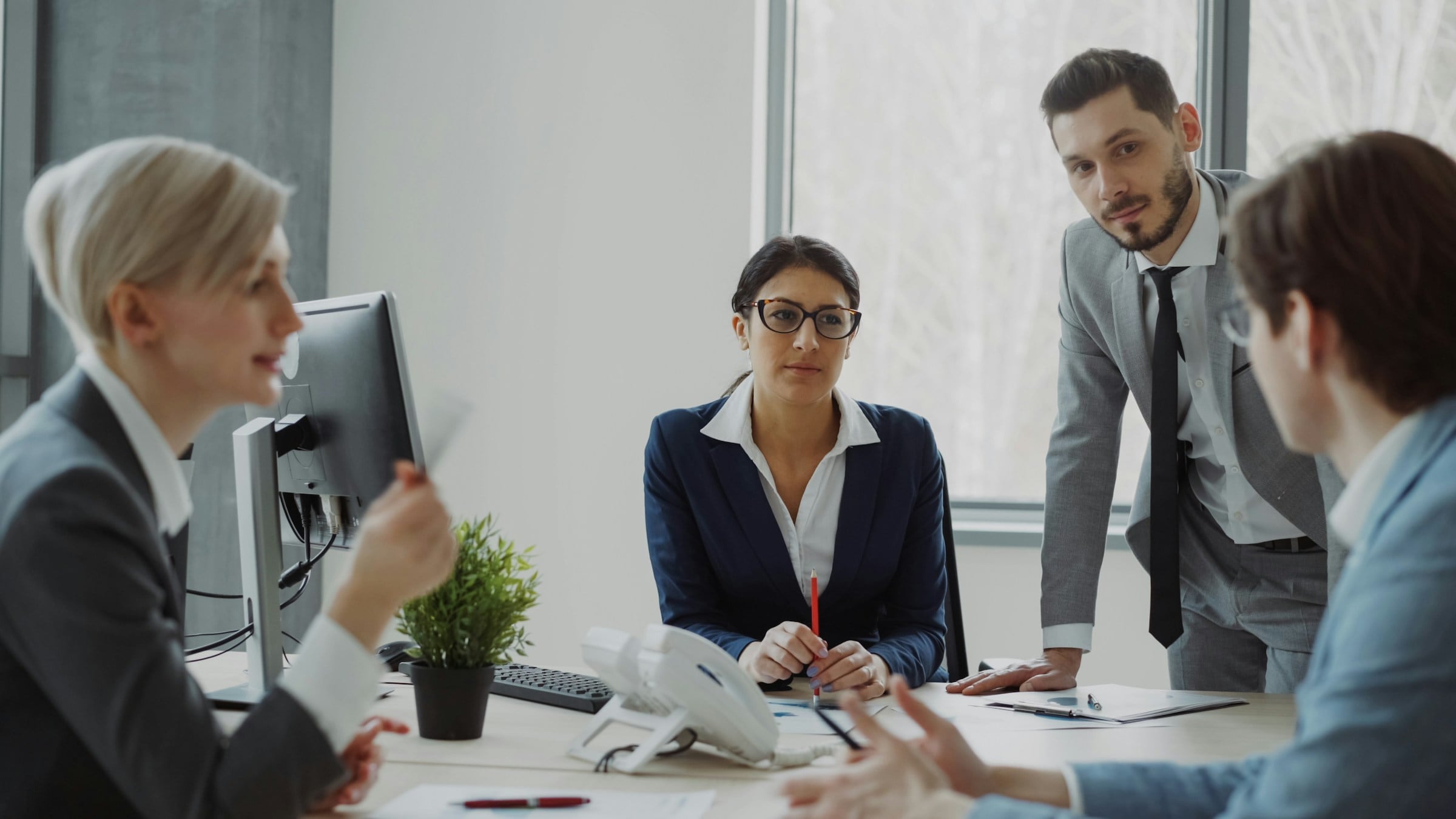 Business team in discussion around a table in a bright office