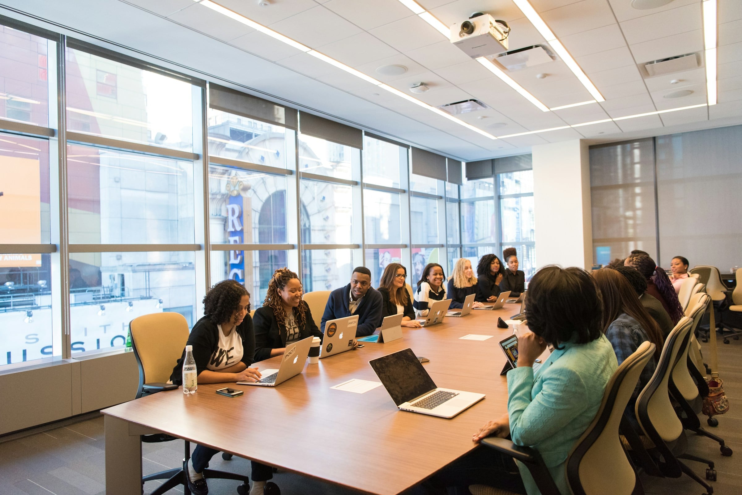 Colleagues working with laptops in a modern open office