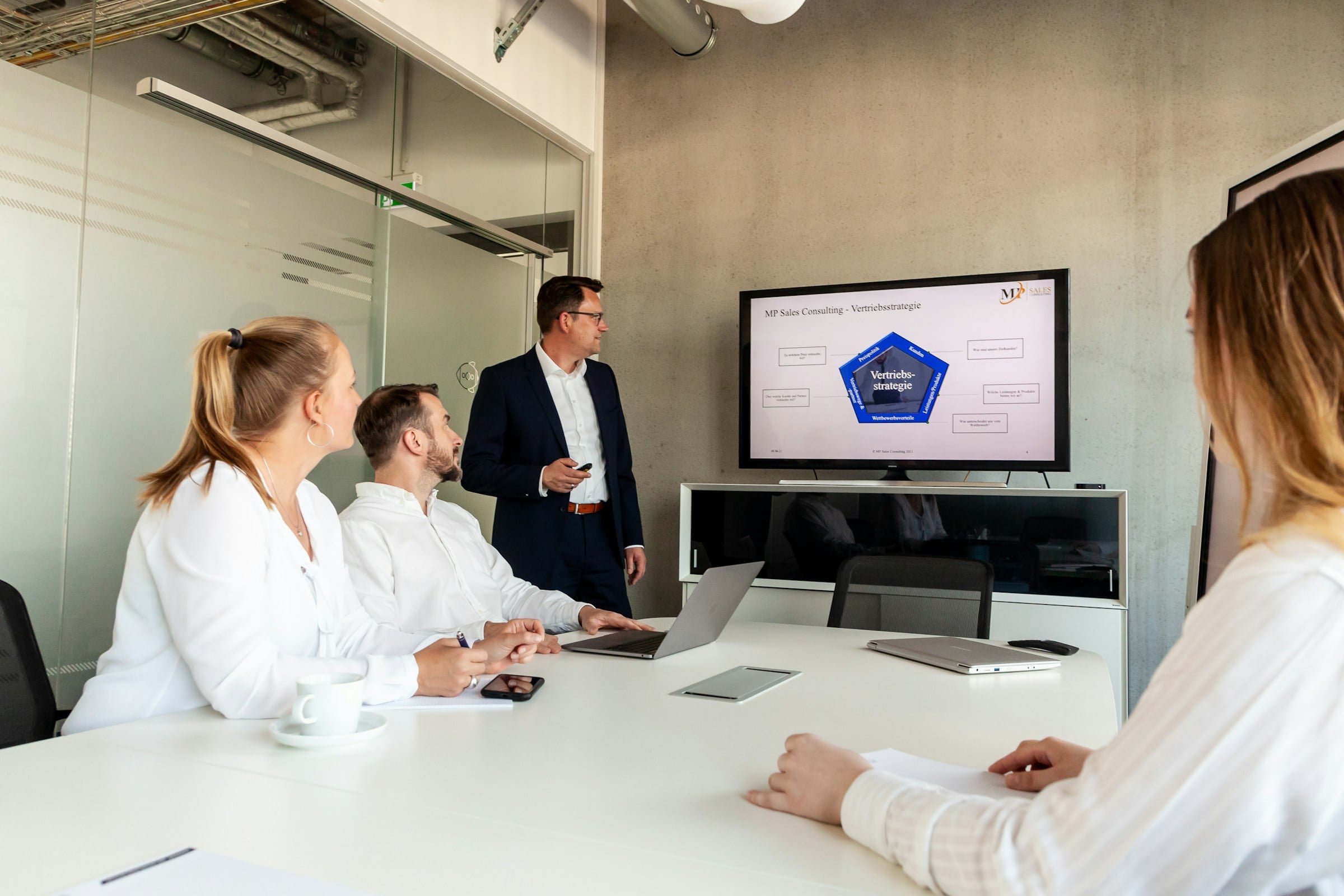 Presenter sharing an update with colleagues in an office meeting