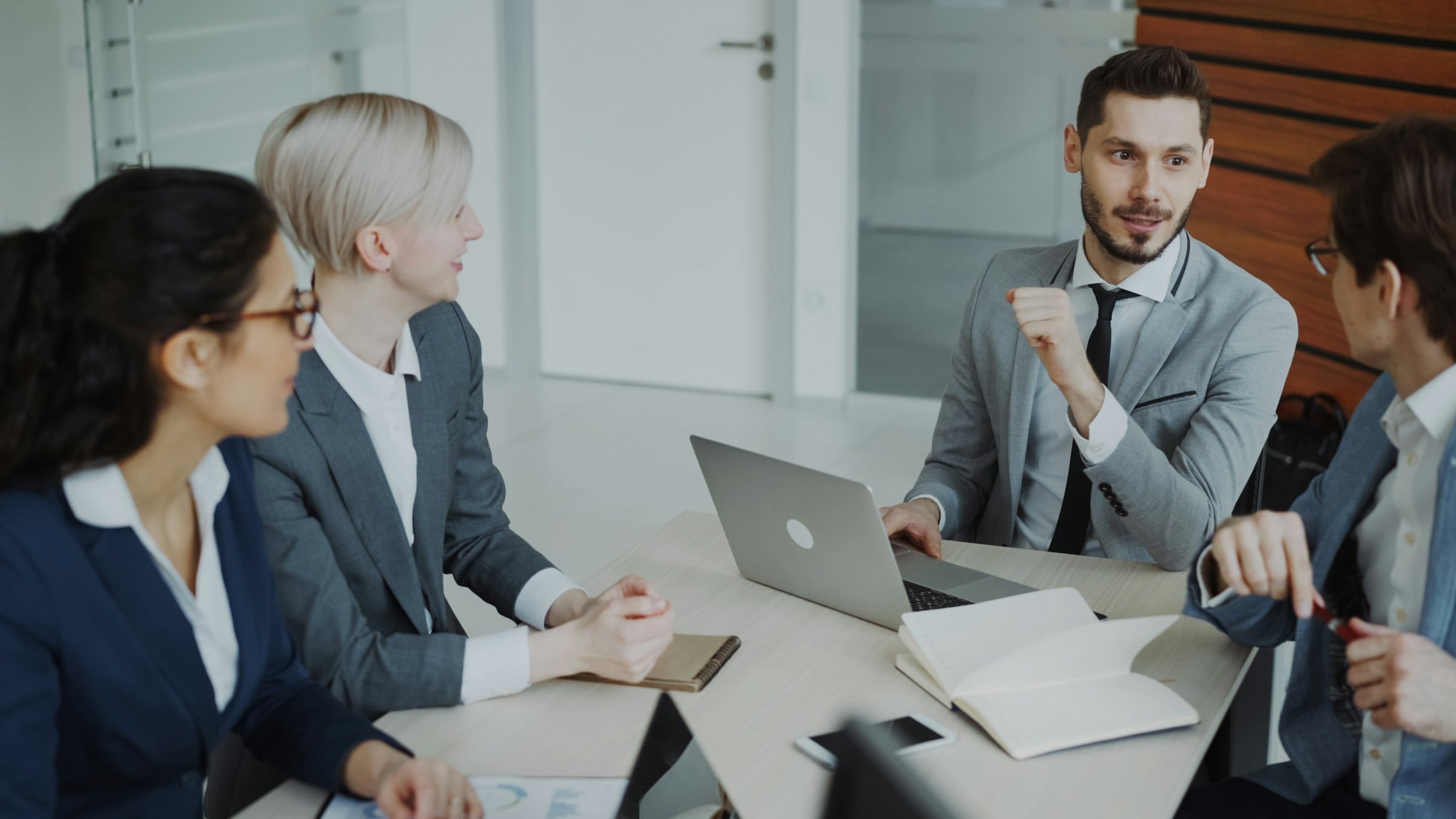 Technology consultants in a meeting with laptops