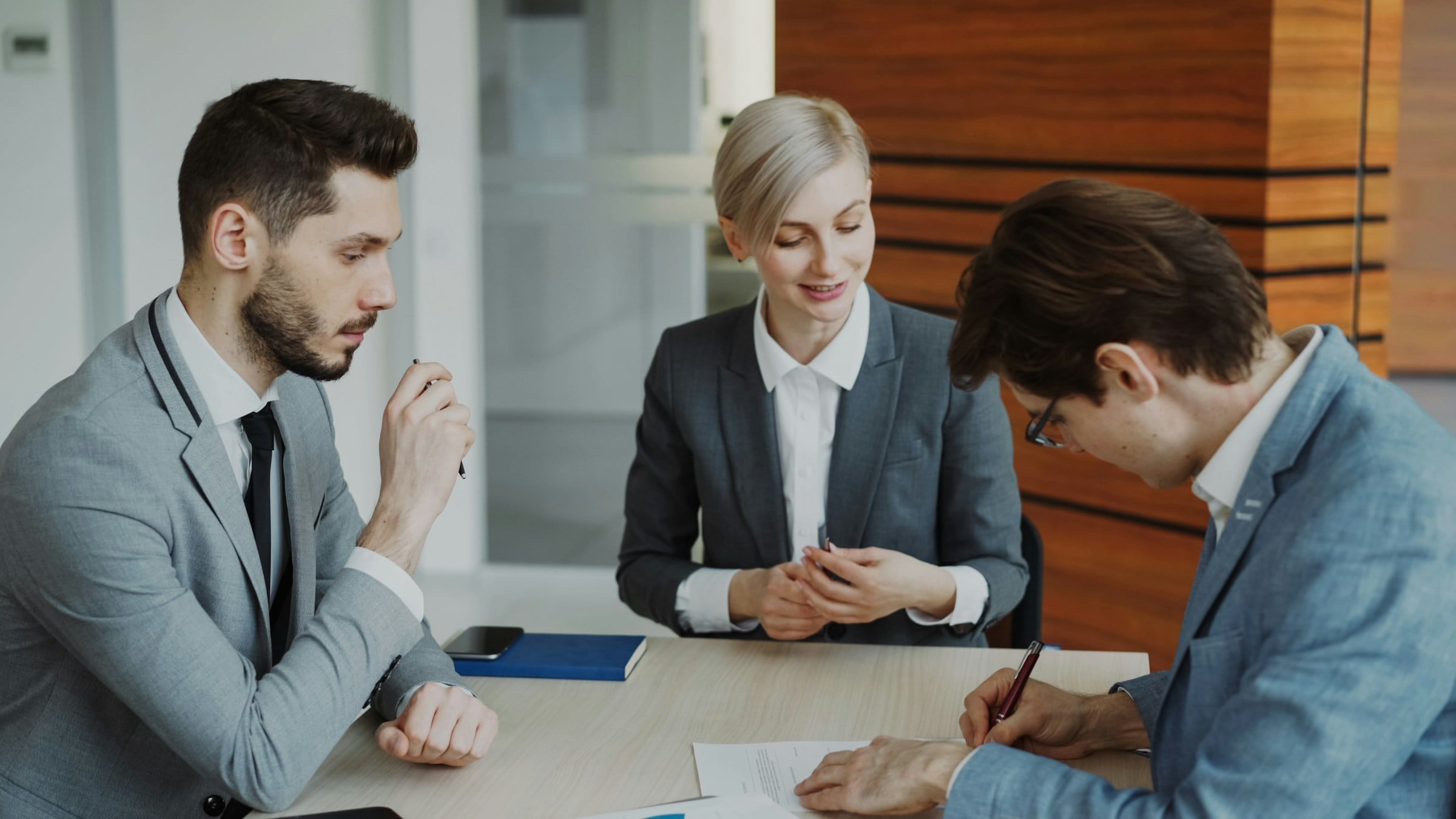 Business partners signing an agreement at a table