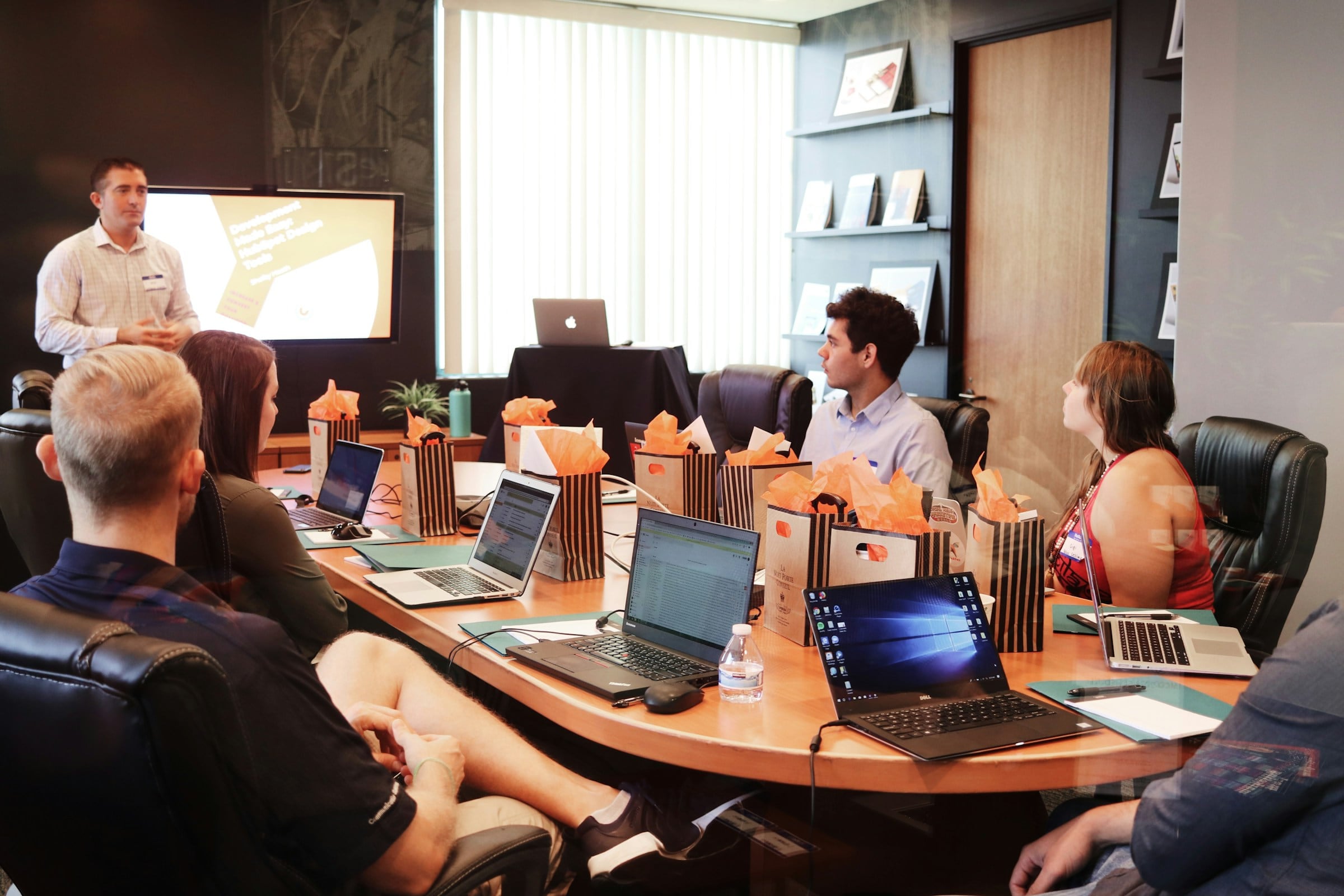Instructor leading an on-site workshop for a group with laptops