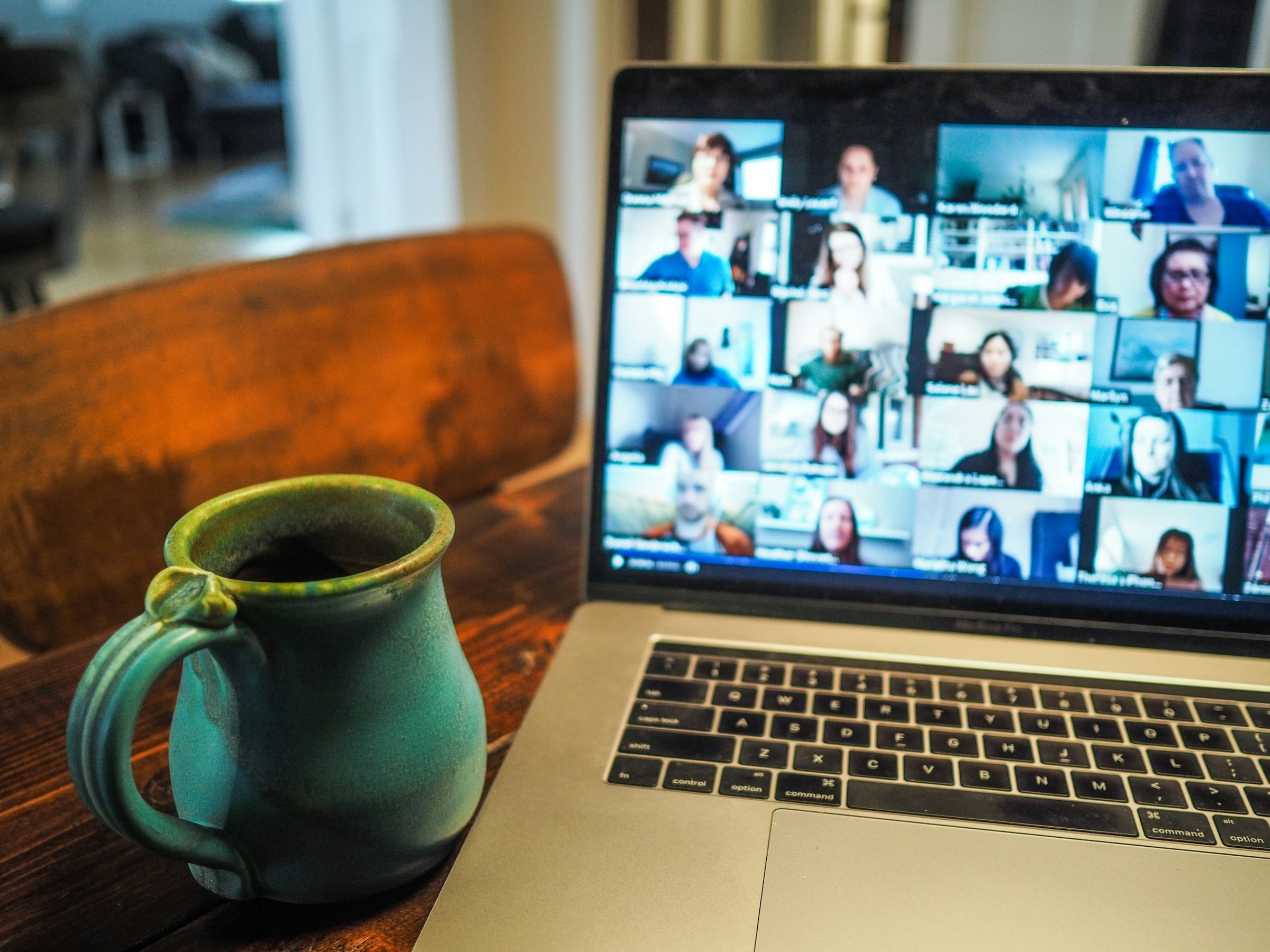 Laptop showing a webinar with many participants